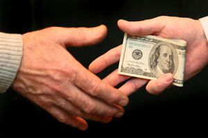 bribe-money-changing-hands