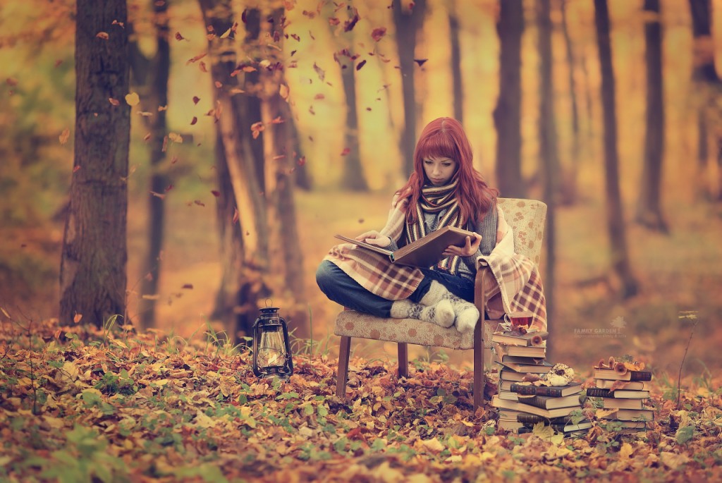 girl reading in fall woods